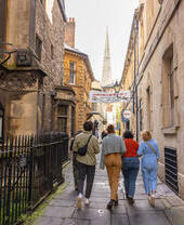 Group of friends walking on a cobbled street.