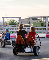 People racing in pedal go-karts