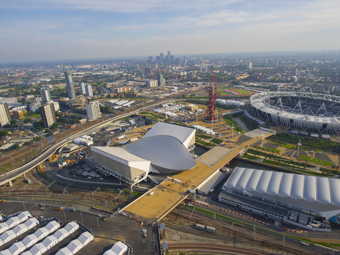 Aerial view of a city with stadium and modern buildings