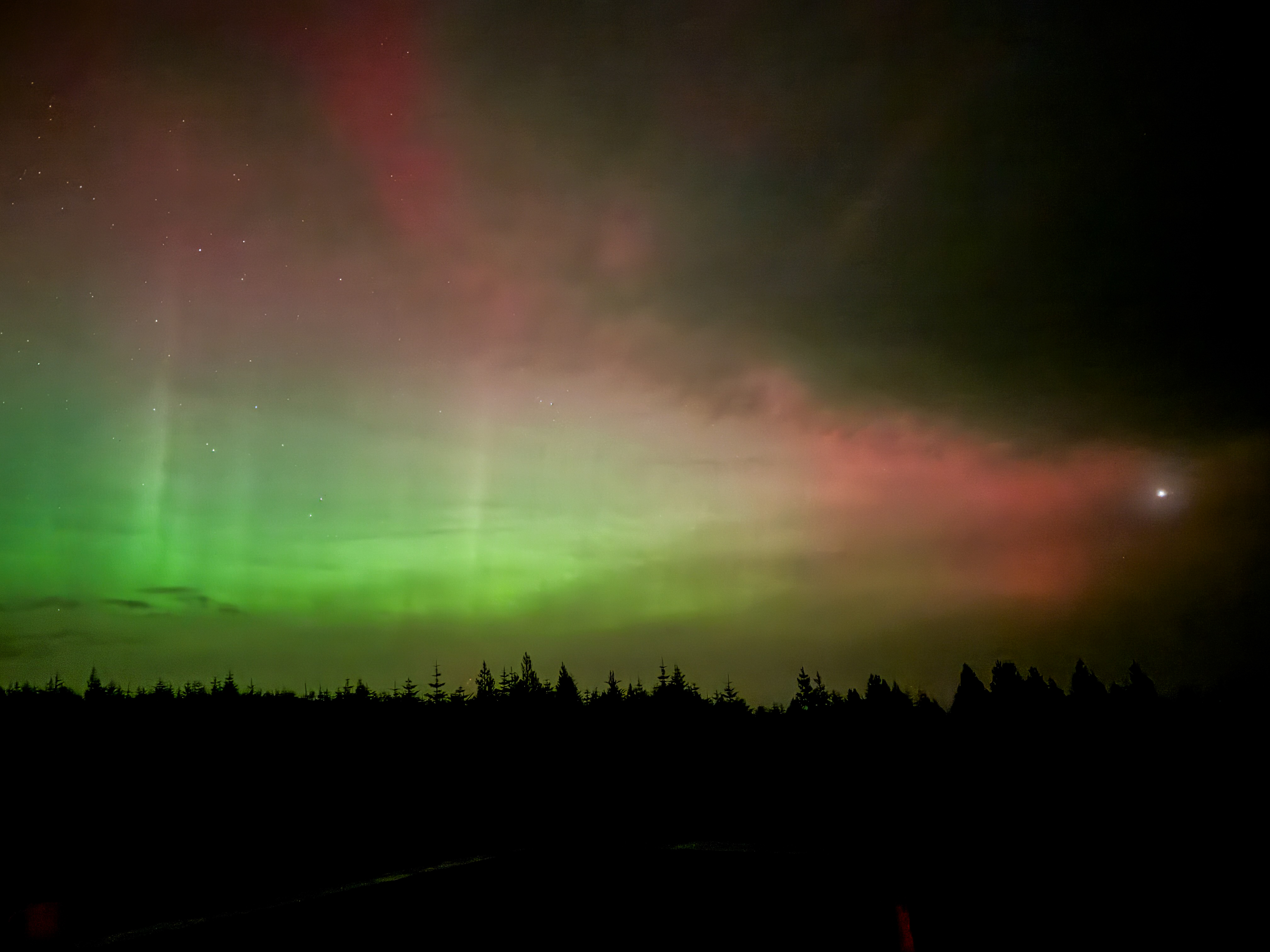 A landscape image of the Northern Lights seen from a Dark Skies Park.