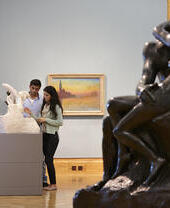 Man and woman viewing artwork in a museum