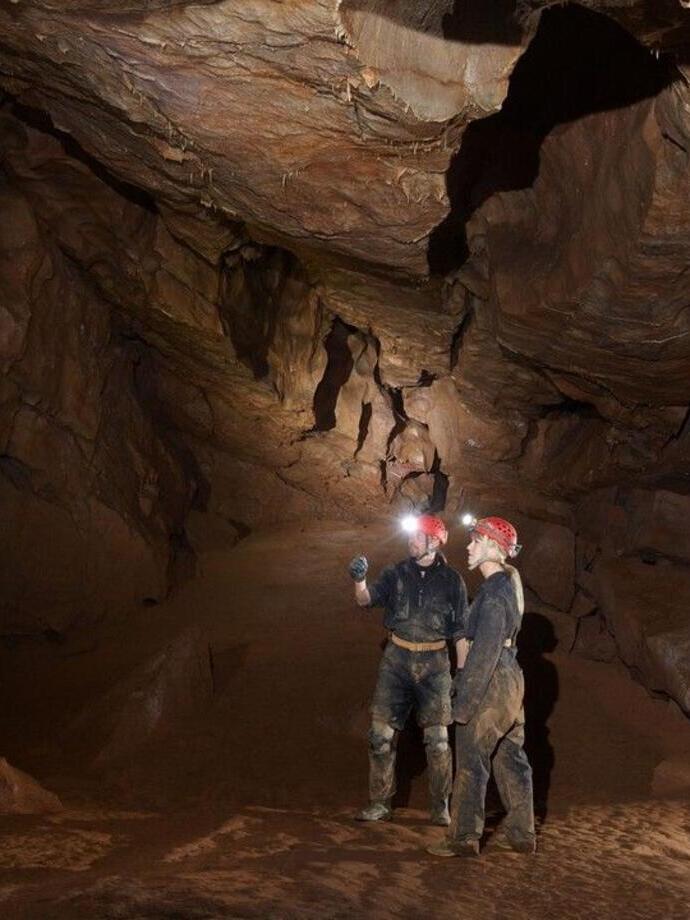 Two people caving at Cheddar Gorge Caves
