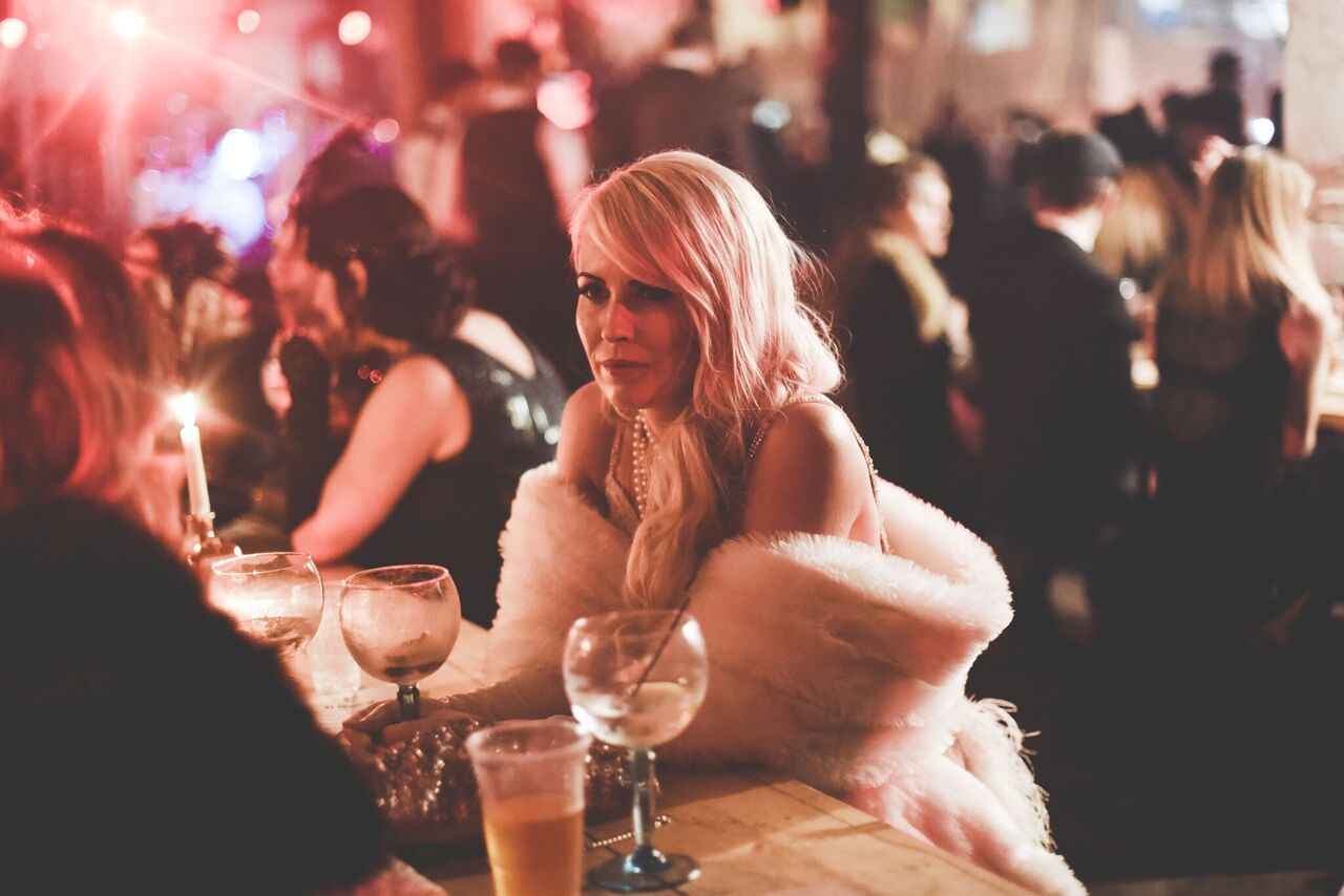 A woman sat at a table with a drink at Depot in Cardiff