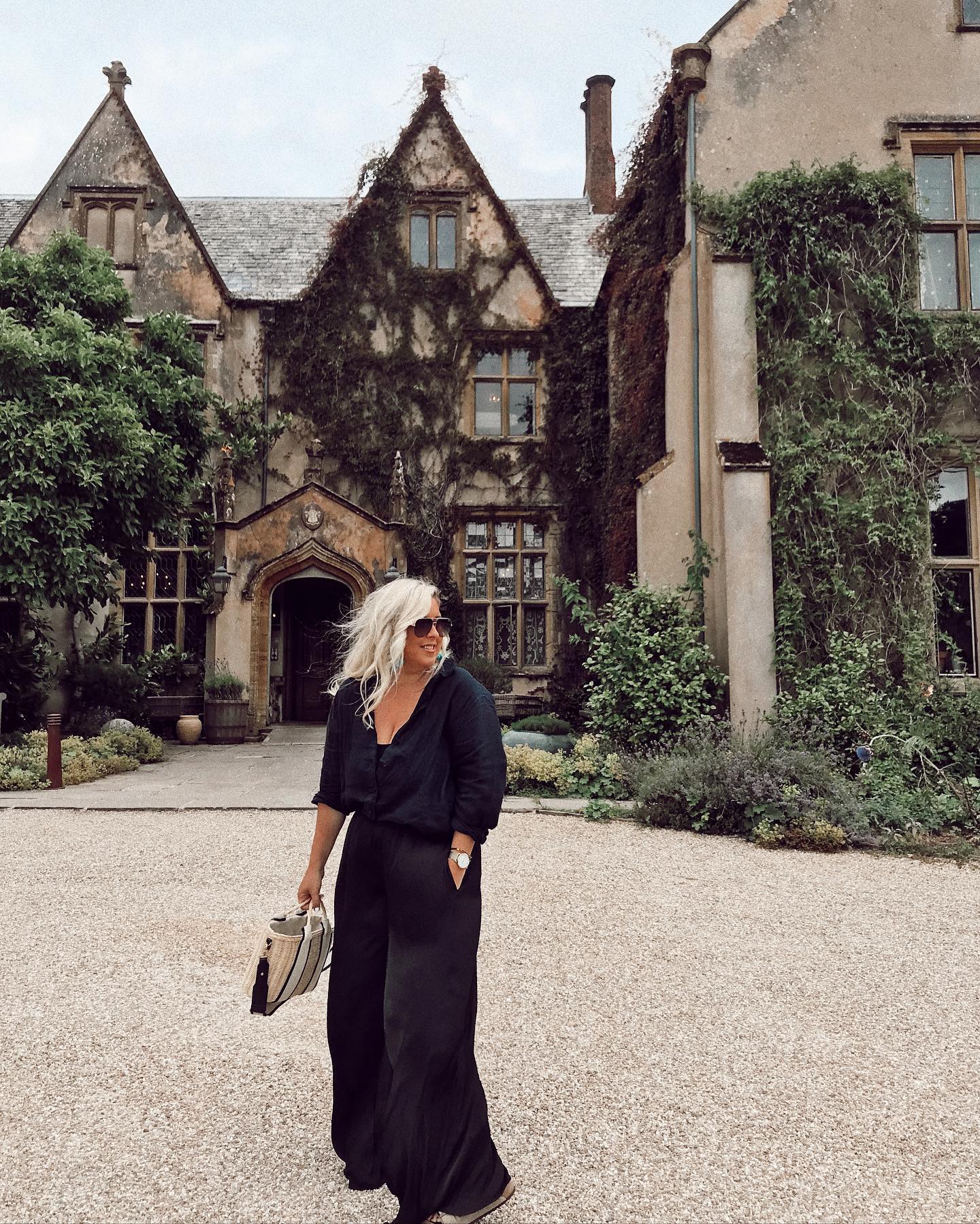 A woman stood outside The Pig Hotel in Combe, Devon