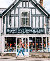 Woman walking past a bookshop