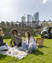 People having a picnic as part of a taxi tour in Manchester