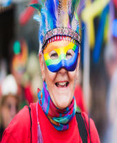 Close up of person with a rainbow mask, smiling