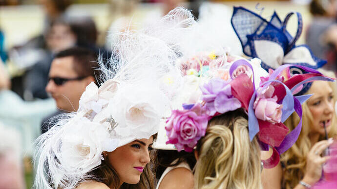 People attending a horse race meeting, smartly dressed