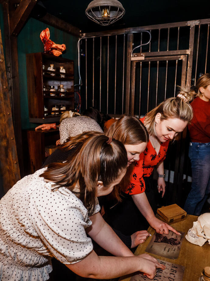 Five friends trying to work their way out of a small escape room