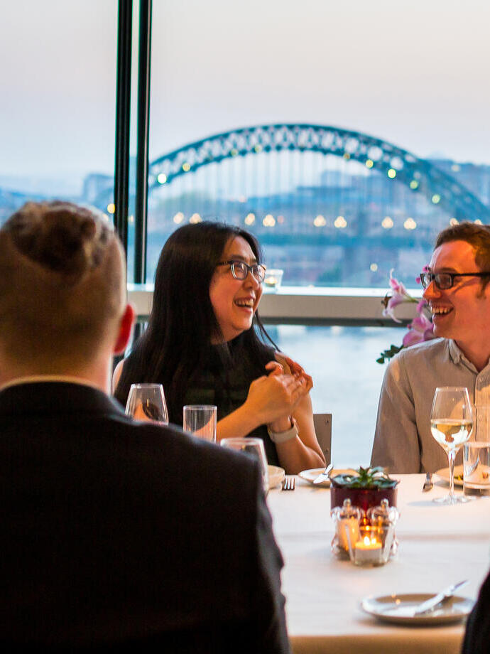 A group of people enjoying dinner at Six Restaurant in Newcastle upon Tyne