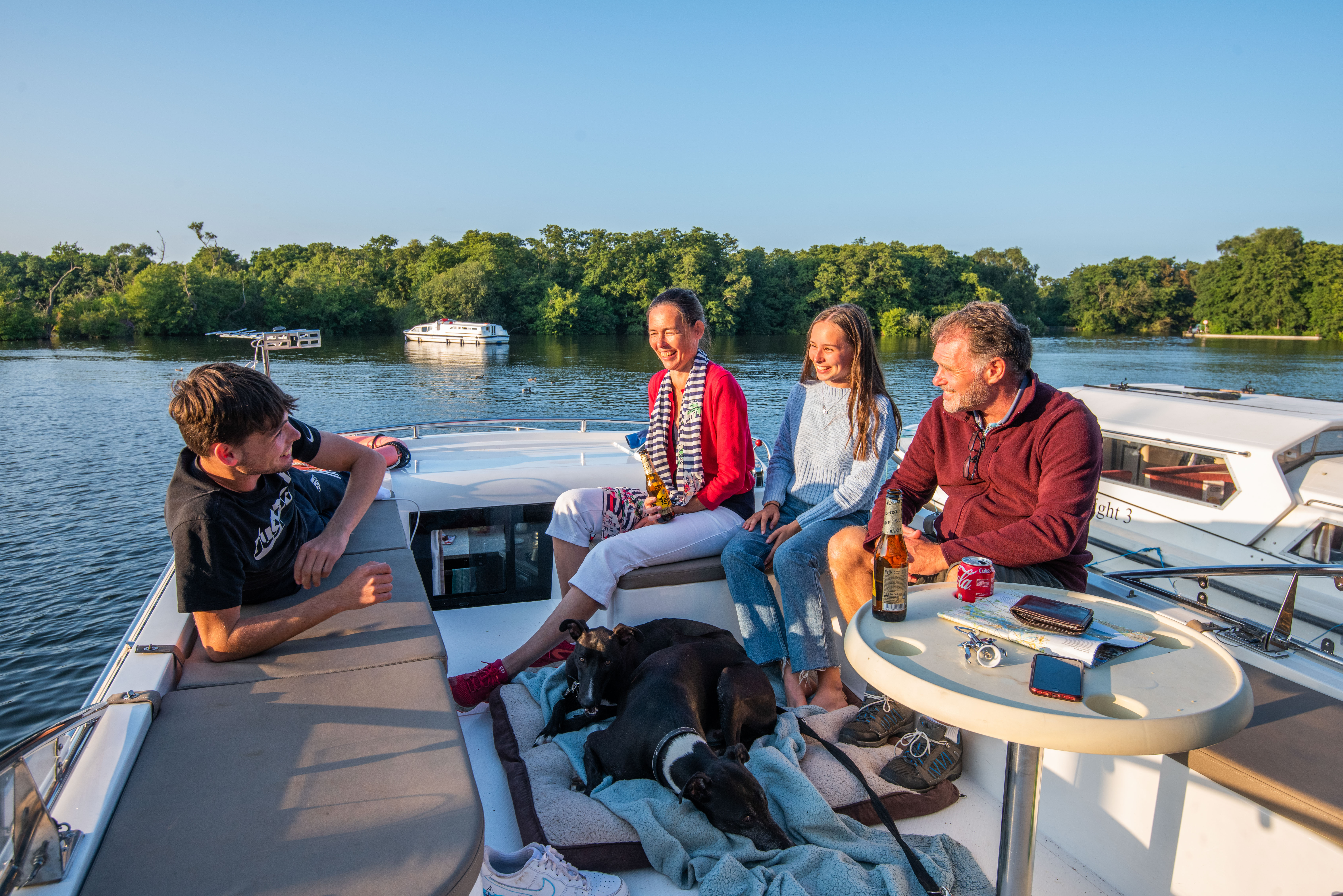 A family relaxing on a boat in the Broads