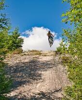 Person on bike going over hill