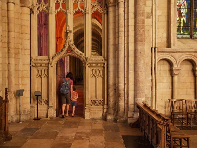 A woman and child exploring the interior of Norwich Cathedral