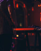 A DJ setting up on stage at a nightclub venue
