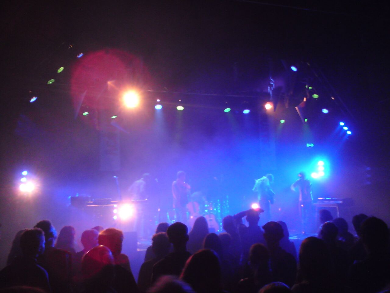 A band performing on stage at concert venue