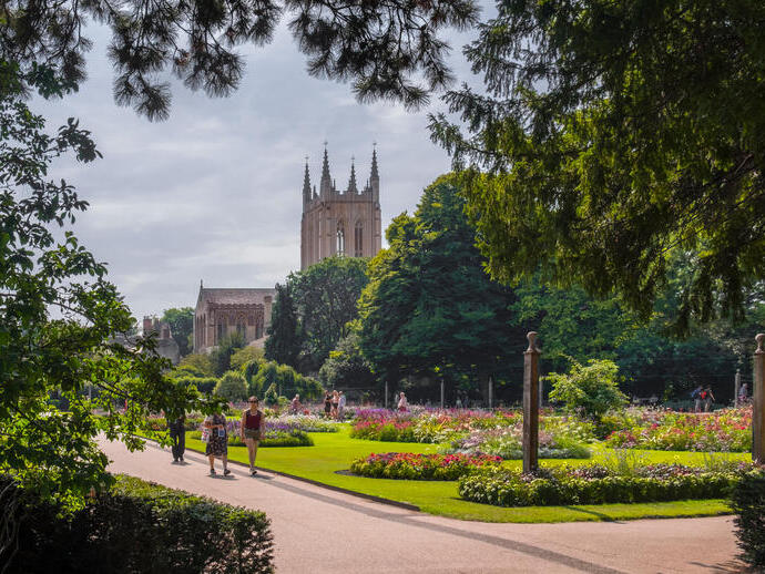 A cathedral amongst manicured gardens on a summer's day
