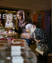 Tourists shopping in Princes Square shopping centre.