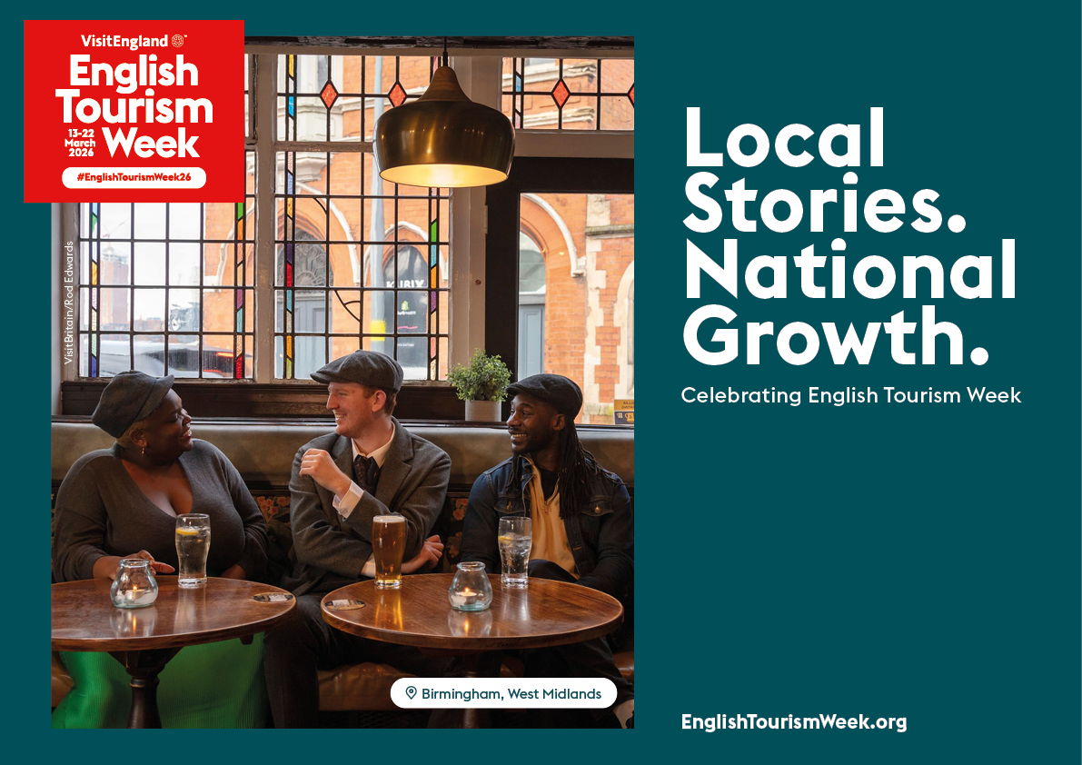 Three people sit and chat in a pub in Birmingham, West Midlands, promoting English Tourism Week 2024. Stained glass window in background.