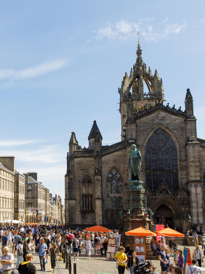 People walking in a city centre on a sunny day