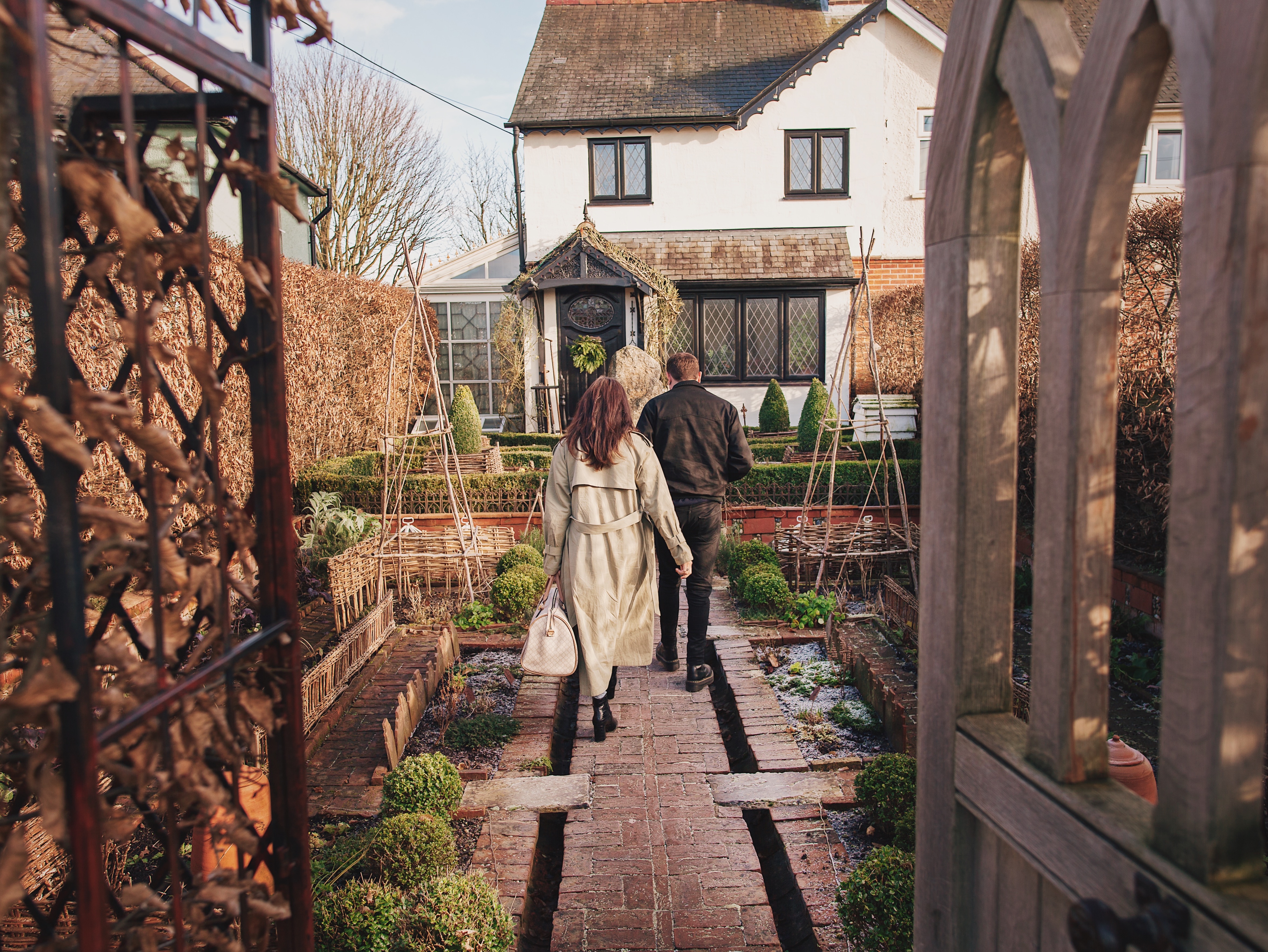 Man and woman walking towards a house