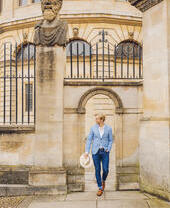 Man walking through a sandstone archway