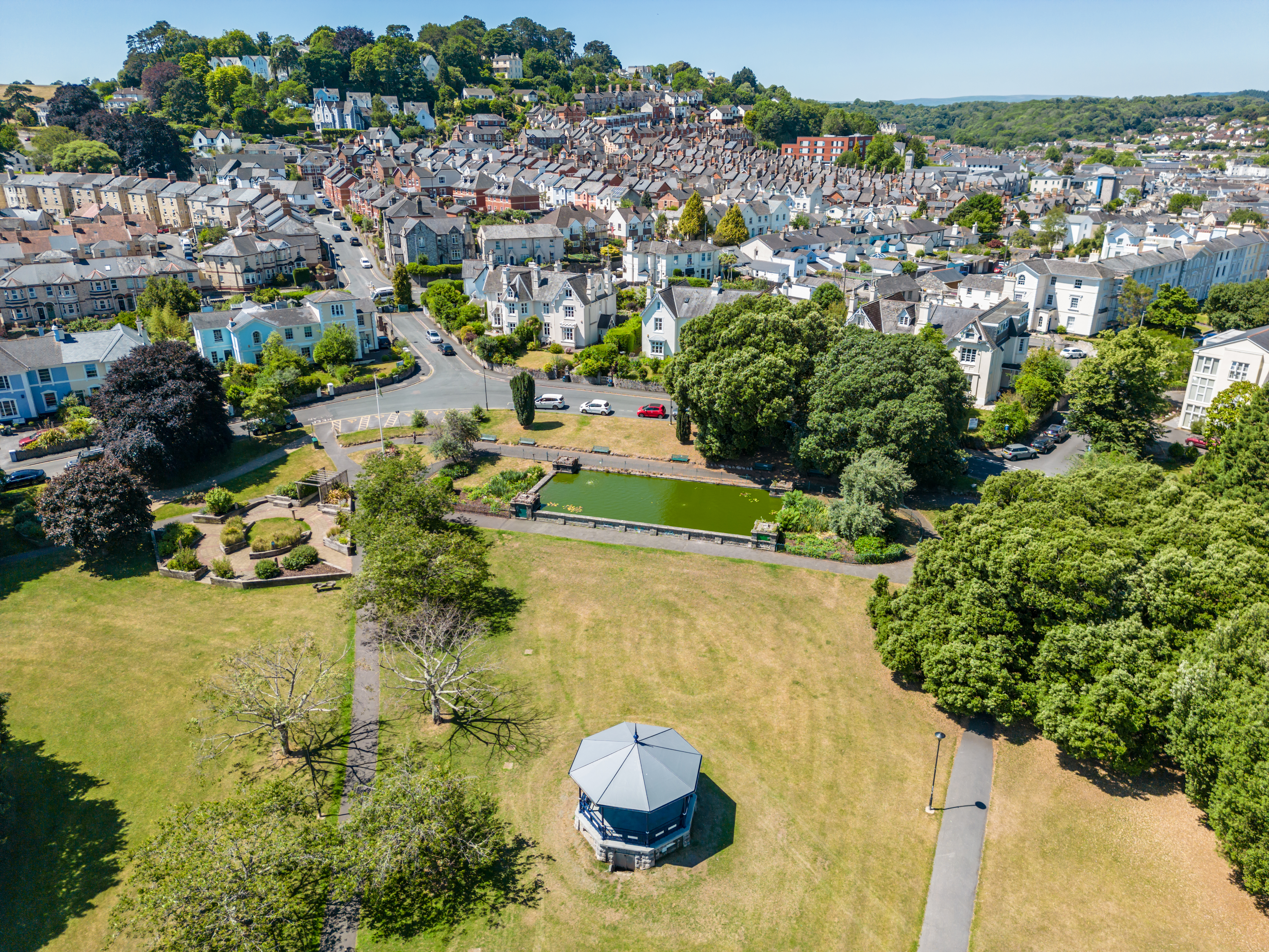 View over a rotunda in a park, overlooking a picturesque village.