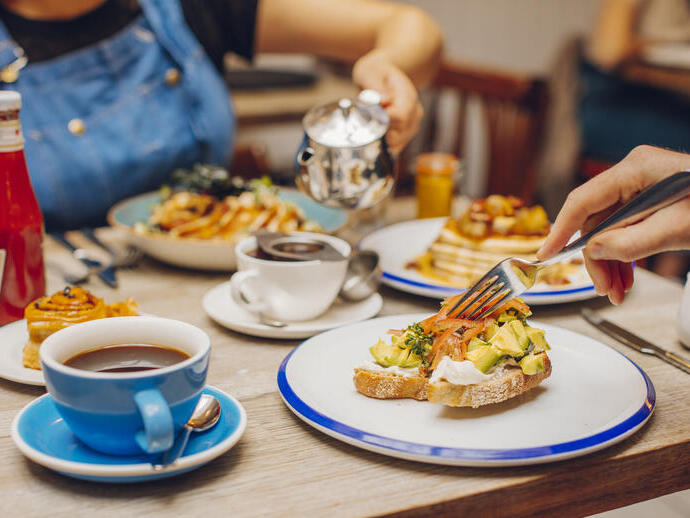 Man and a woman eating food in a restaurant