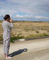A female photographer in the Dungeness Landscape.