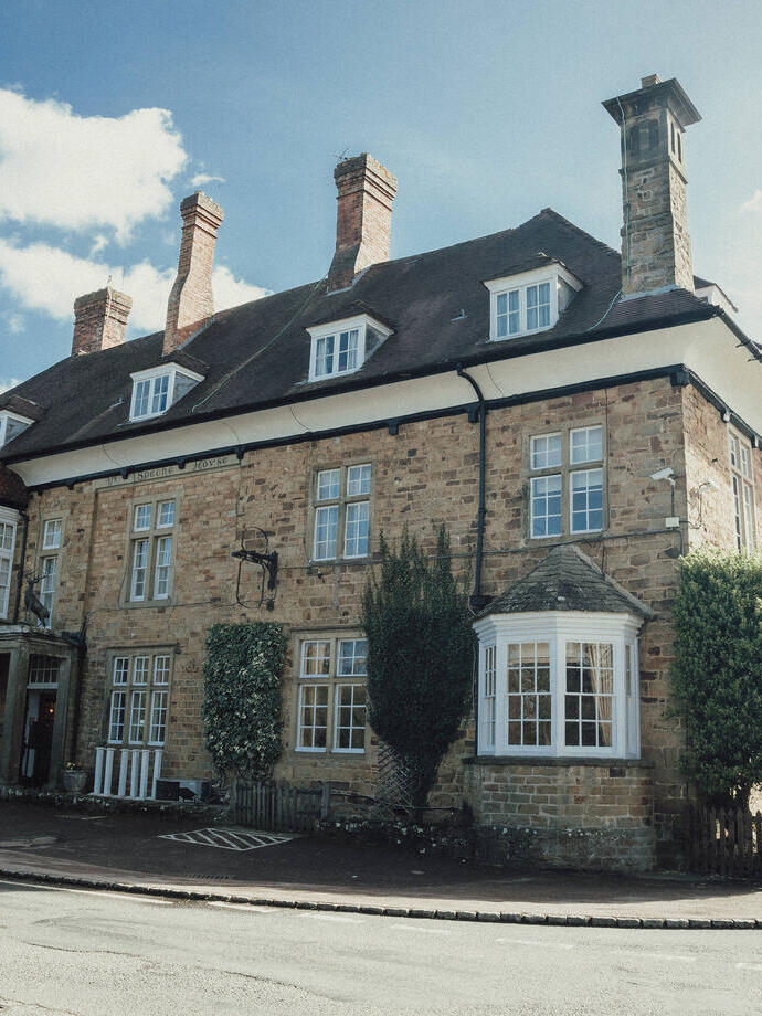 The outside main entrance of a large country village hotel.