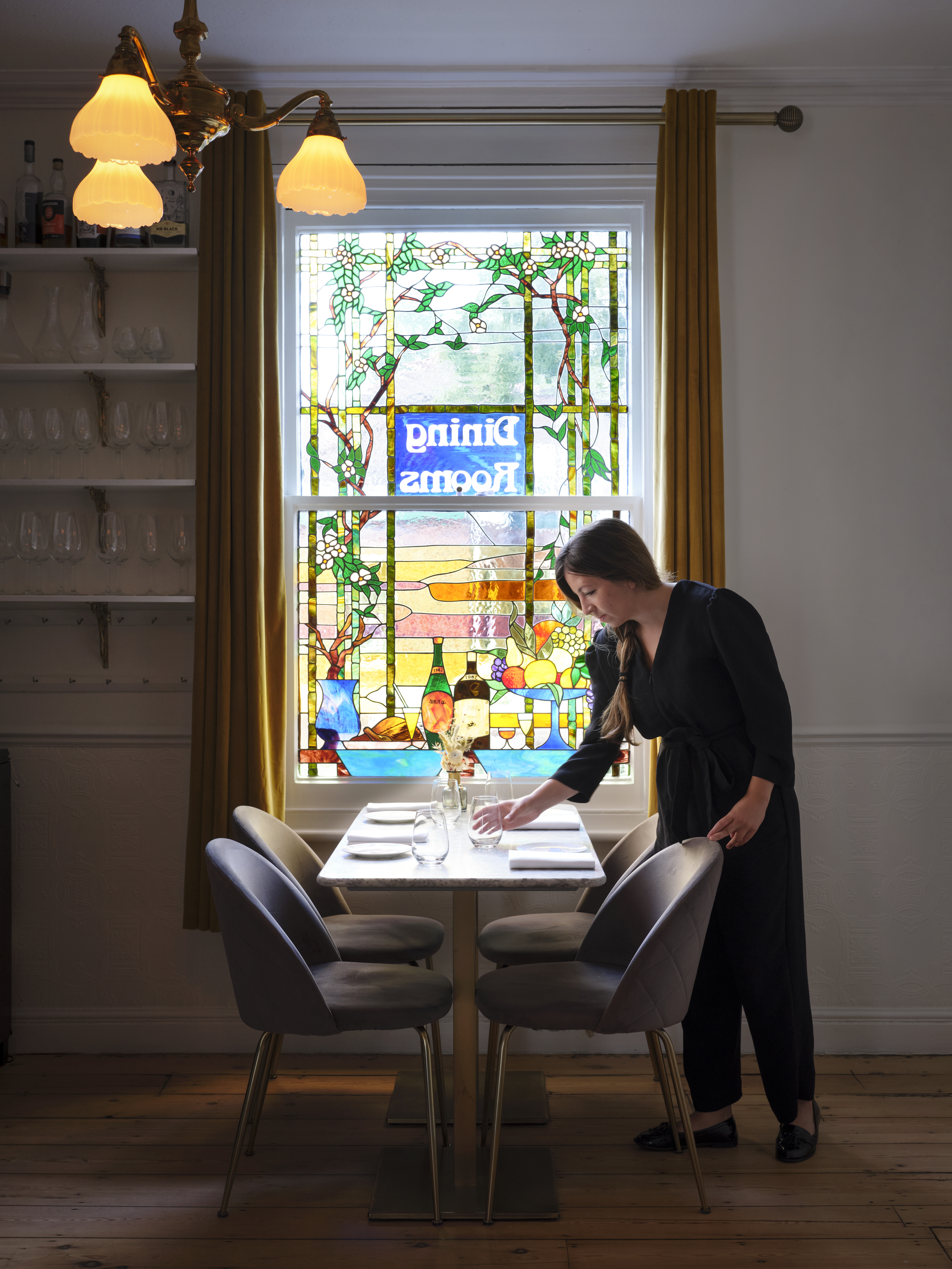 Woman setting a table in a restaurant
