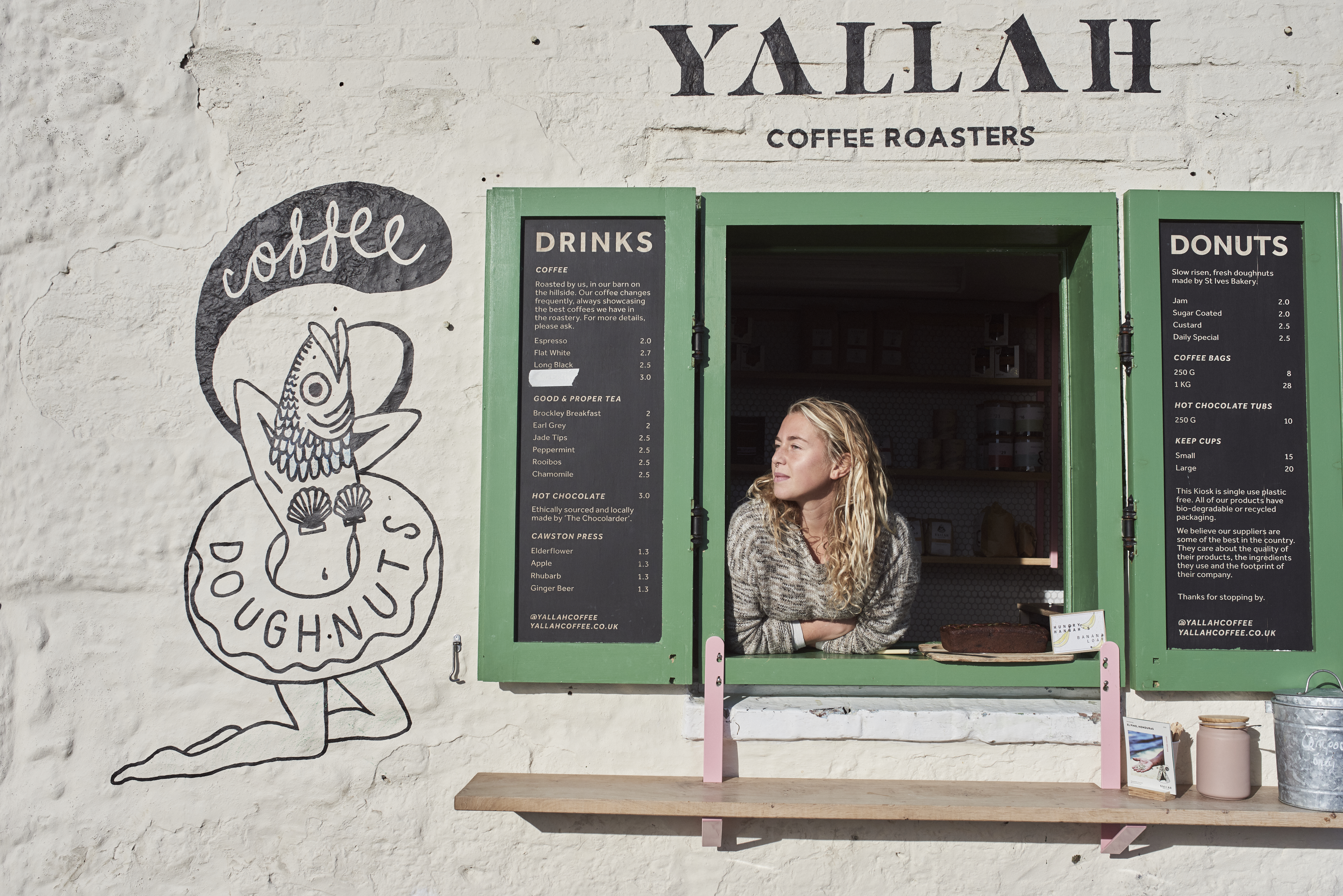Woman looking through a window of a coffee shop