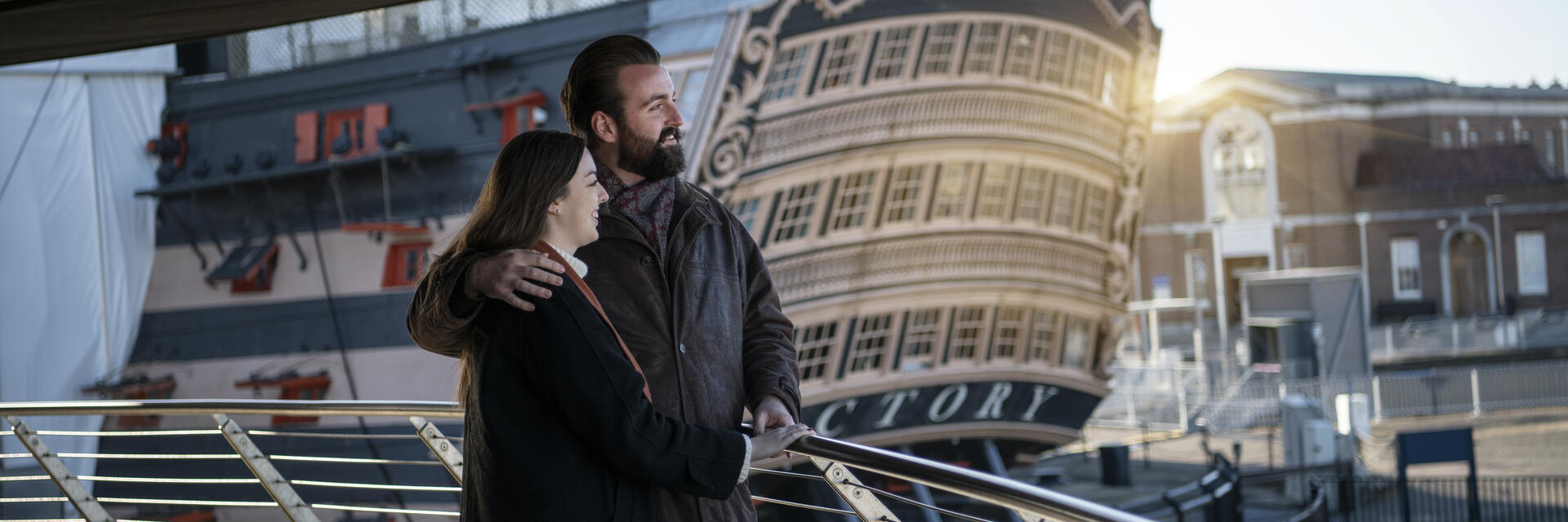 Two people looking over the bow of a ship