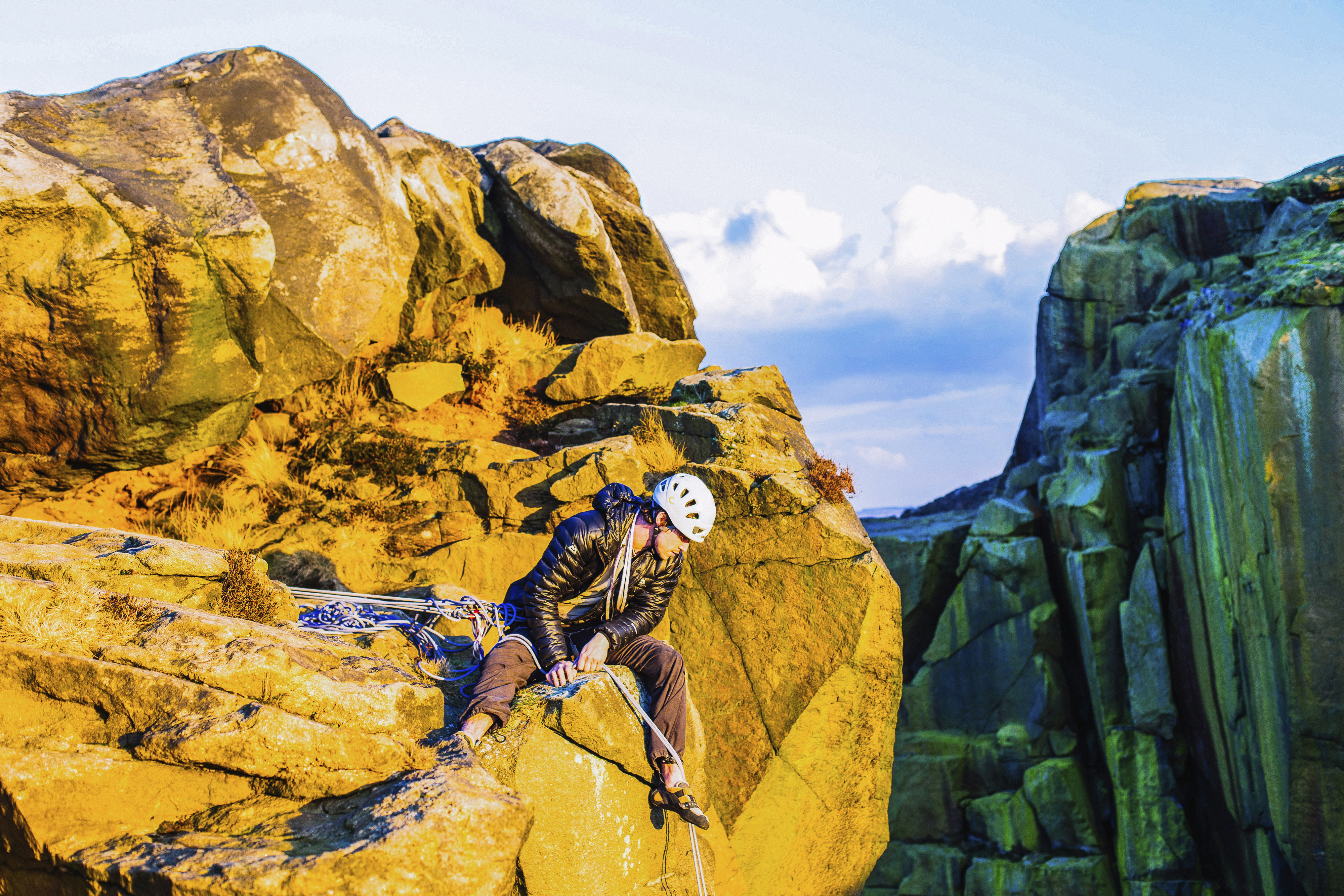 A rock climber considering a descent