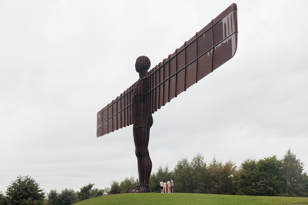 A family group visits the Angel of the North statue near Newcastle upon Tyne.