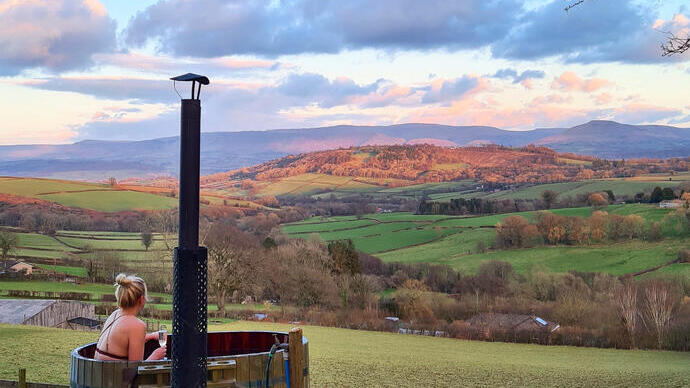 Woman in a hot tub in the countryside