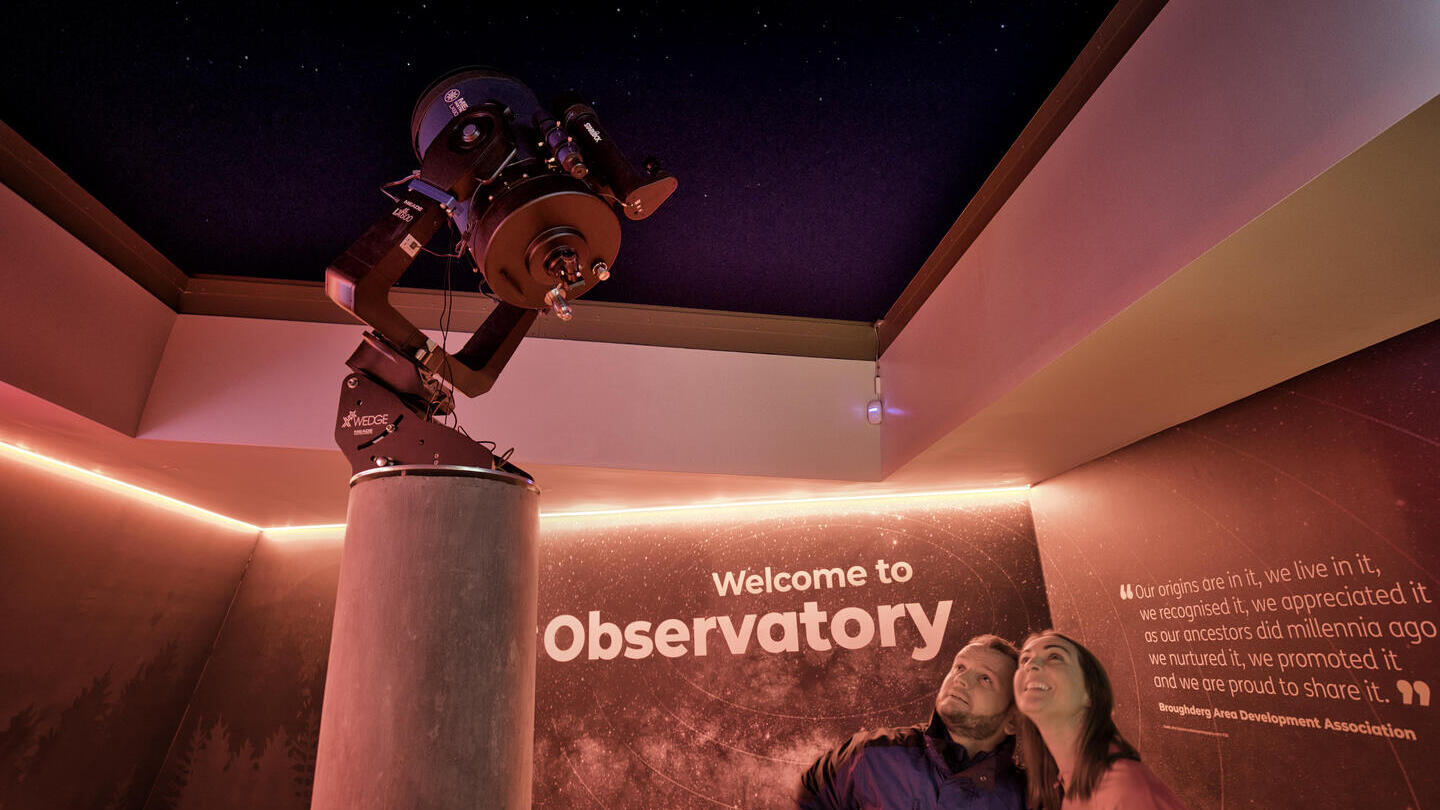 Two people at Dark Sky Park and Observatory viewing the Mead Telescope