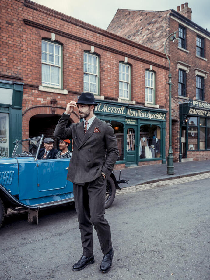 A man dressed in period costume visits a living museum