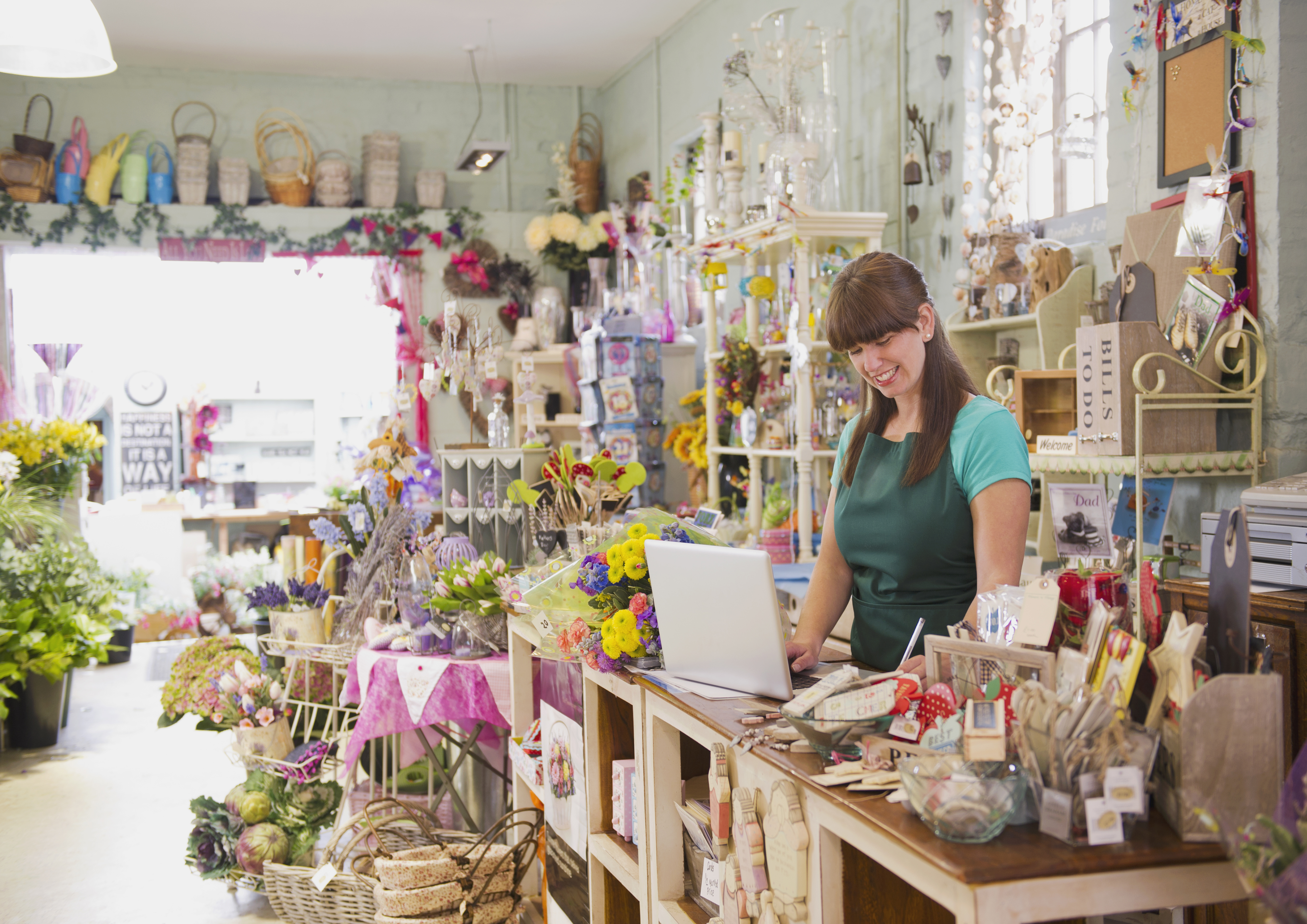 Woman using a laptop in a gift shop