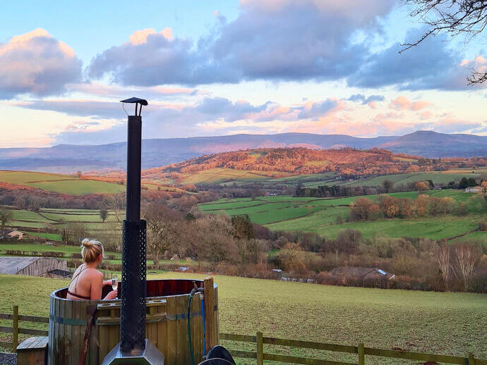 Woman in a hot tub in the countryside