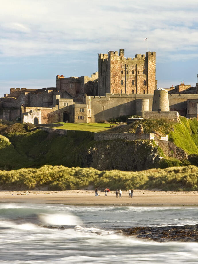 View from a distance of a castle on hill near a beach