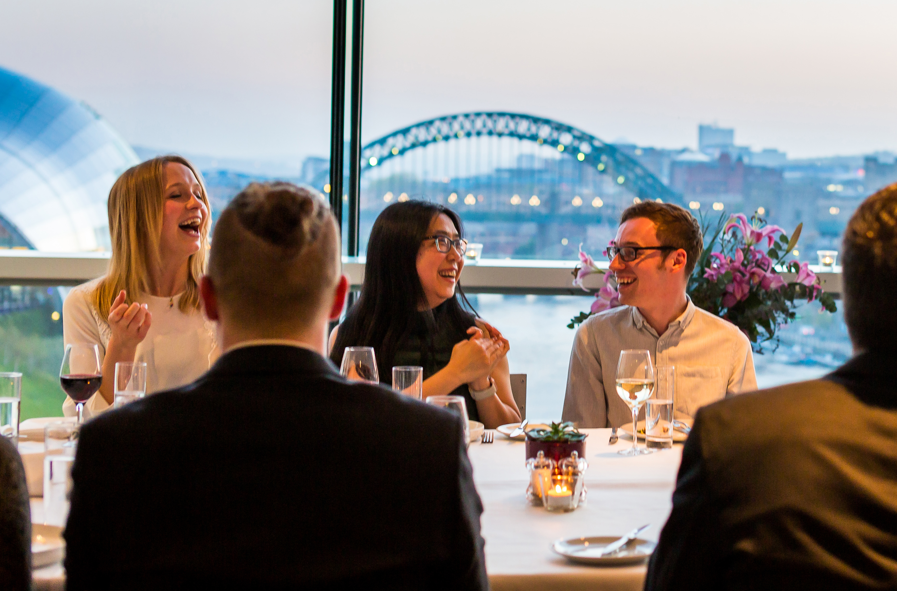 A group of people enjoying dinner at Six Restaurant in Newcastle upon Tyne
