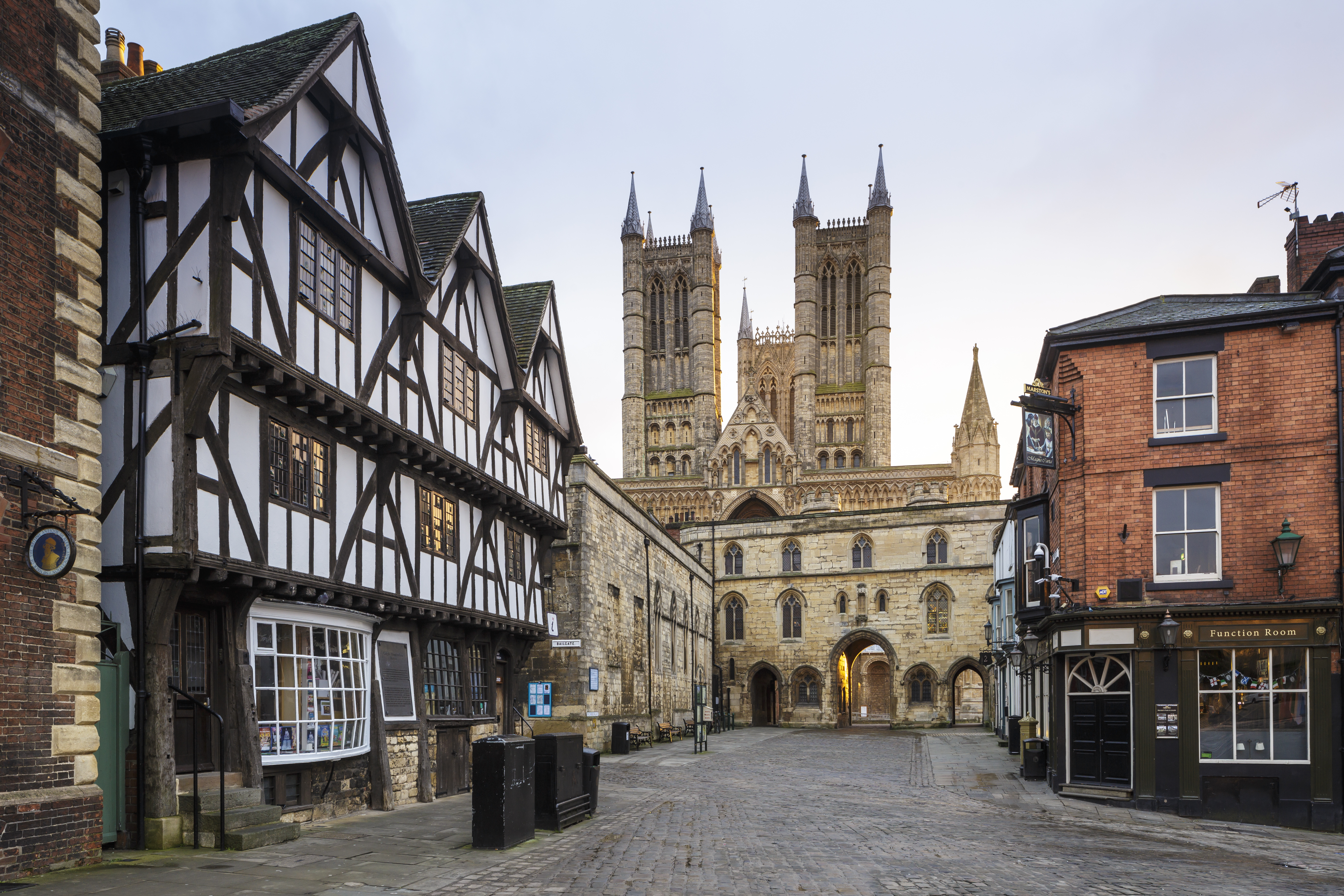 Cathedral with tudor timber framed medieval buildings in foreground