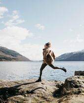 UK, Scotland, young woman running at Loch Lomond