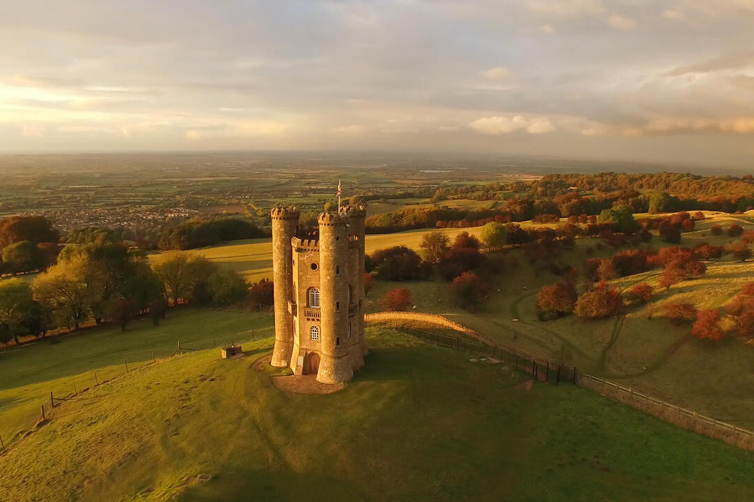 A drone view of an castle tower just at sunset.