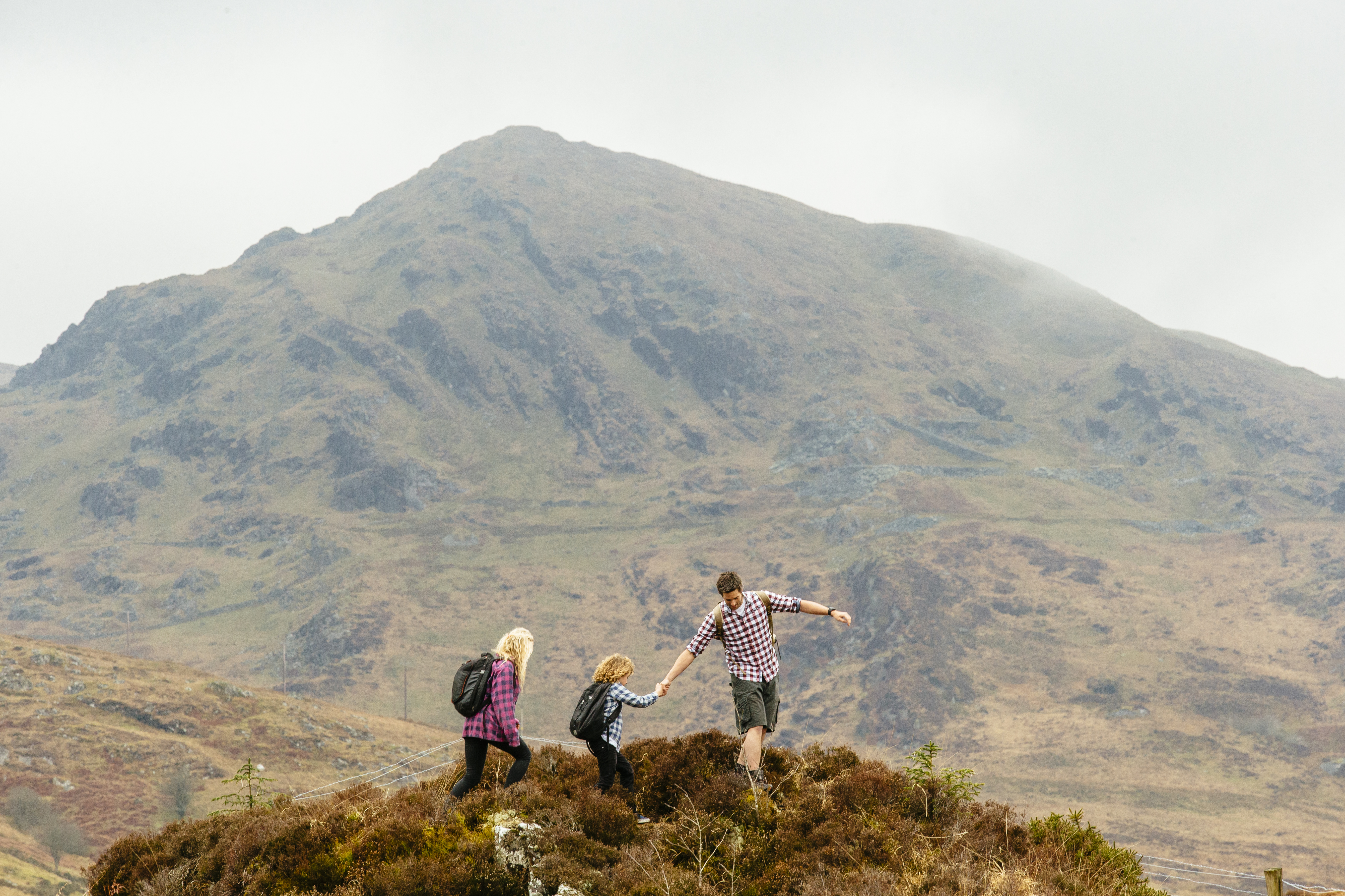 Man, woman and a child walking in the mountains