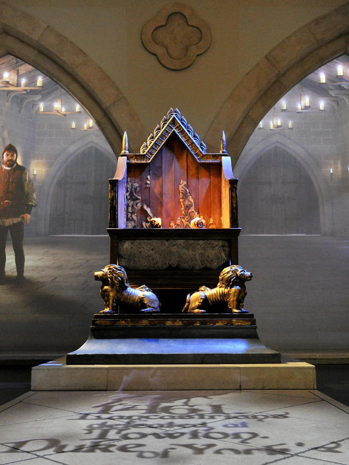 The throne room with archways either side of the throne with views through to the large hall at a visitor centre for a long dead King.
