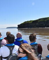 A group of people on a boat tour around Cardiff's bay area