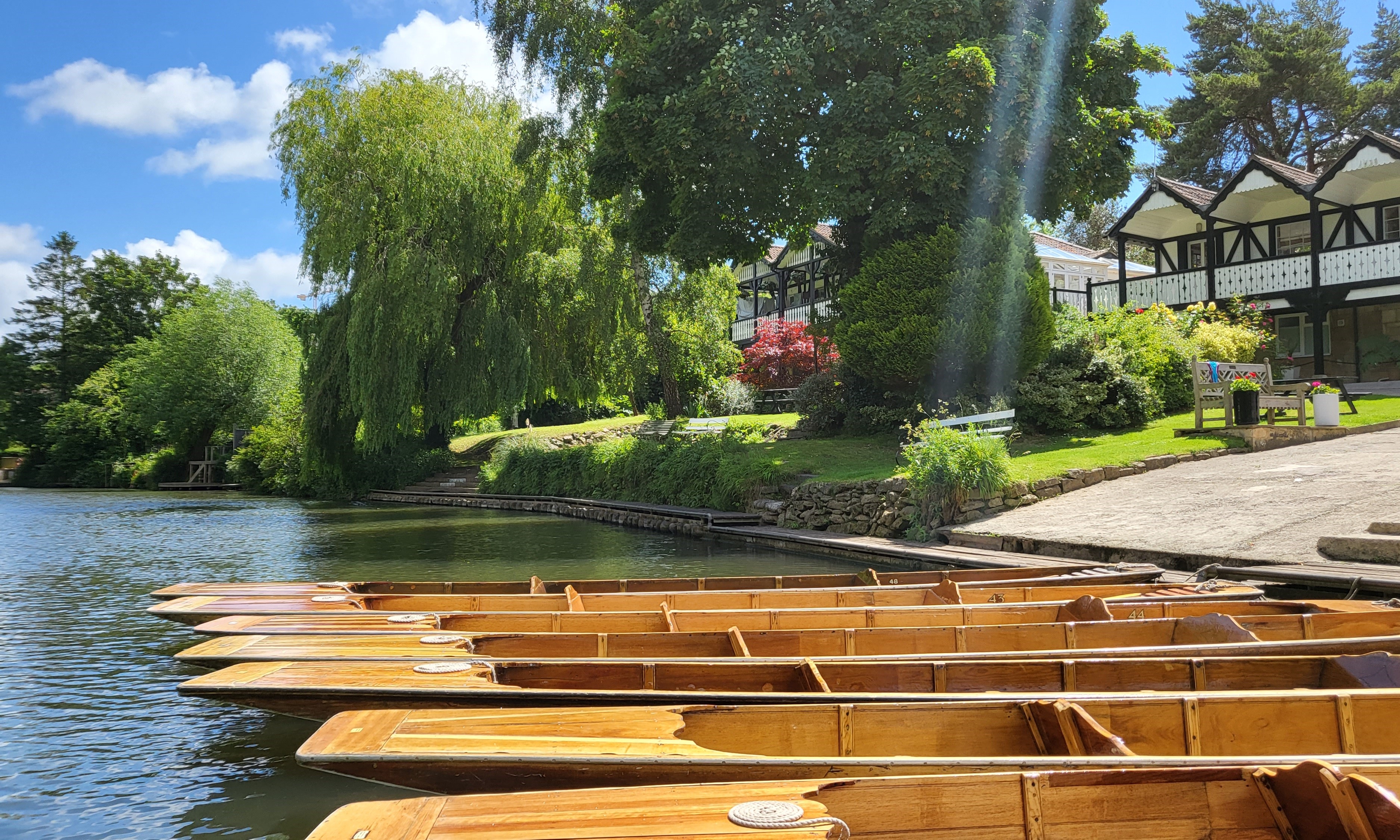 Rows of kayaks lined up on the shore at Bath Boating Station