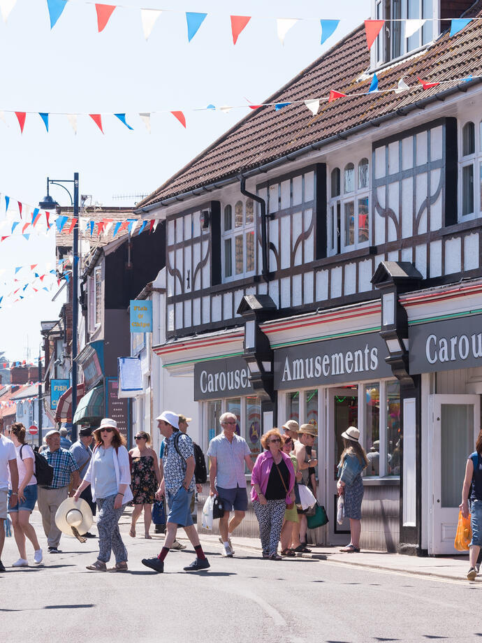Groups of people walking down a shopping street in Sheringham