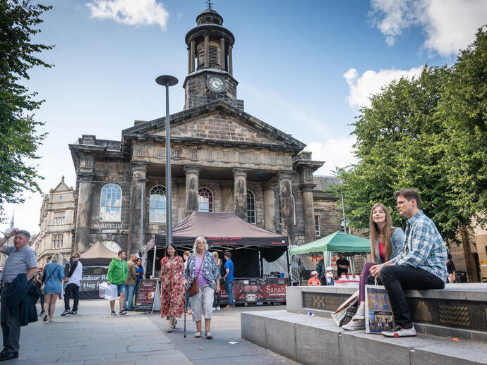 Groups of people exploring the city centre of Lancaster